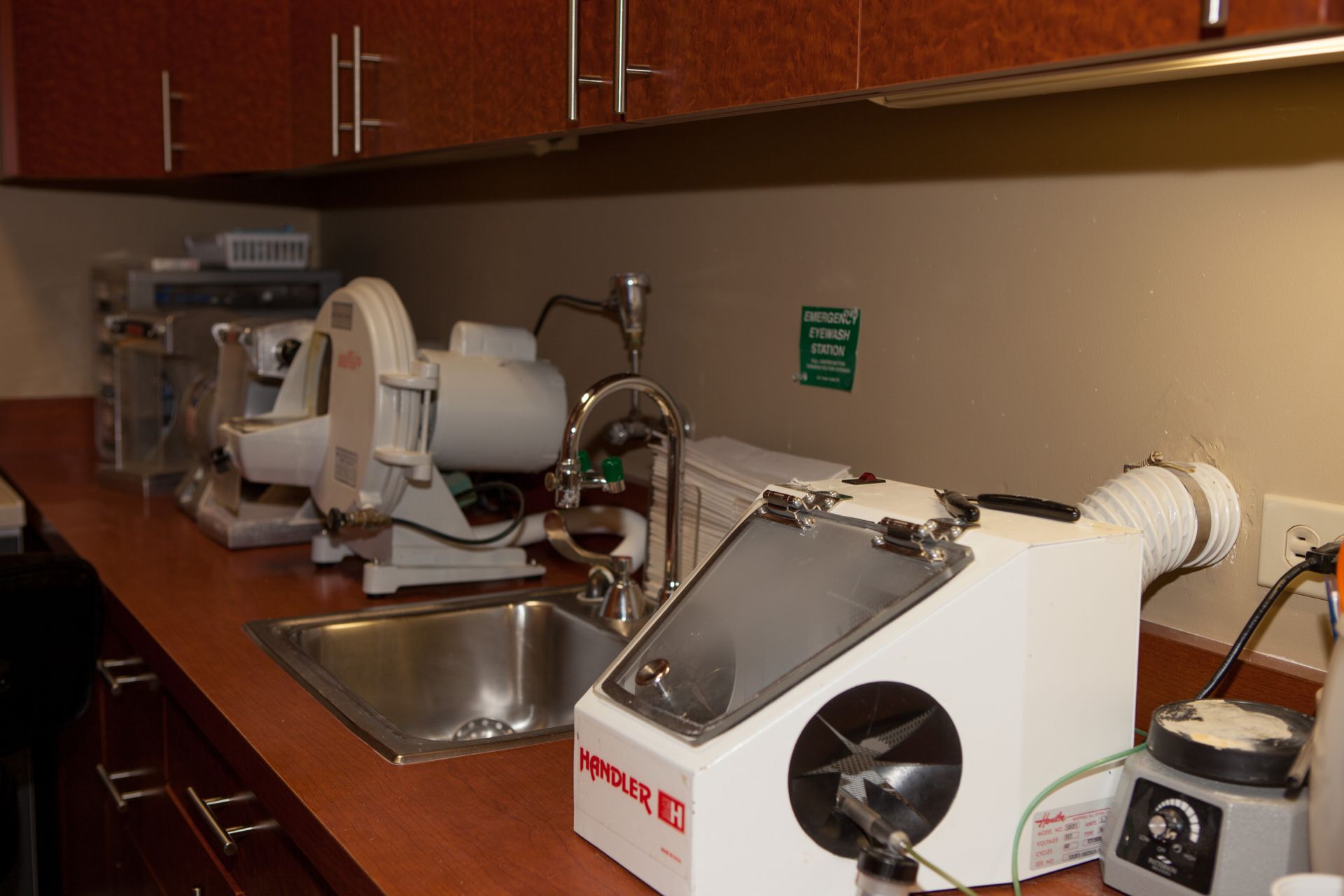 A kitchen counter with a sink and a machine that says 3m on it.