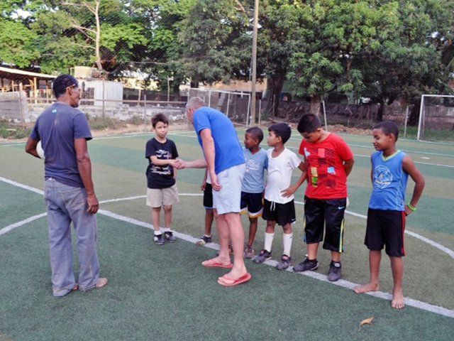 A group of young boys are standing on a soccer field