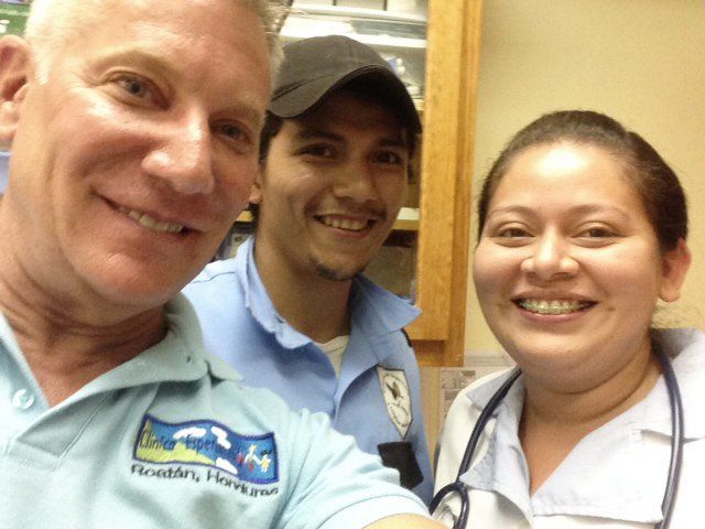 A man wearing a shirt that says florida parks smiles with two other people
