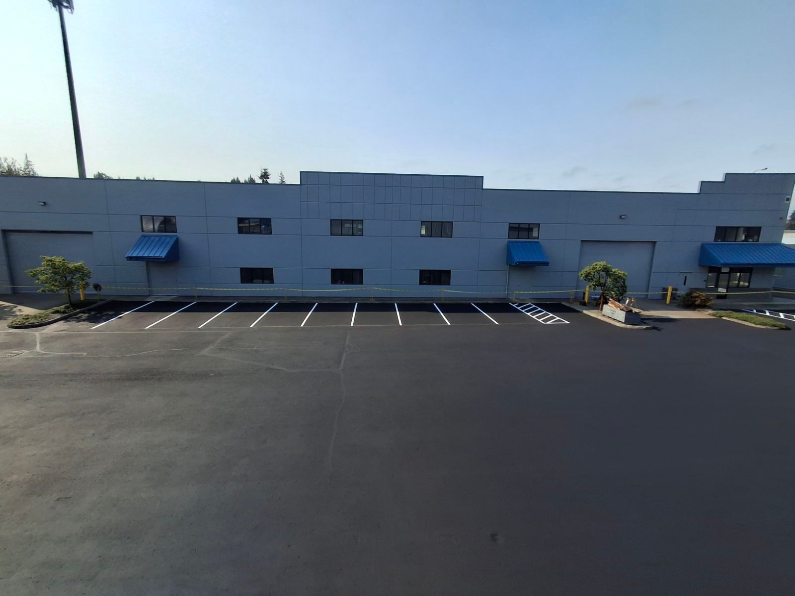 A large blue building with a parking lot in front of it