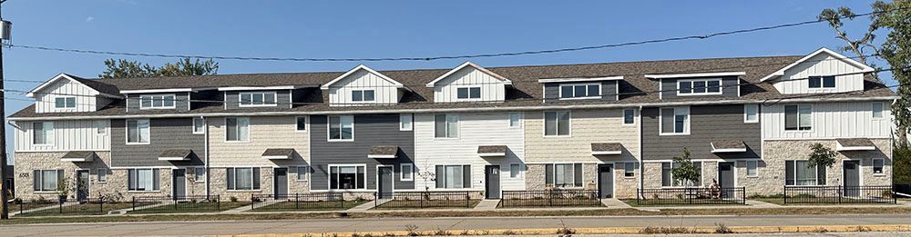 Row of modern townhomes with gray and white siding
