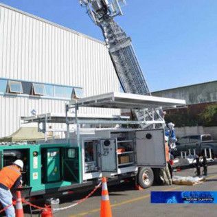 A man is standing next to a truck with a ladder attached to it.