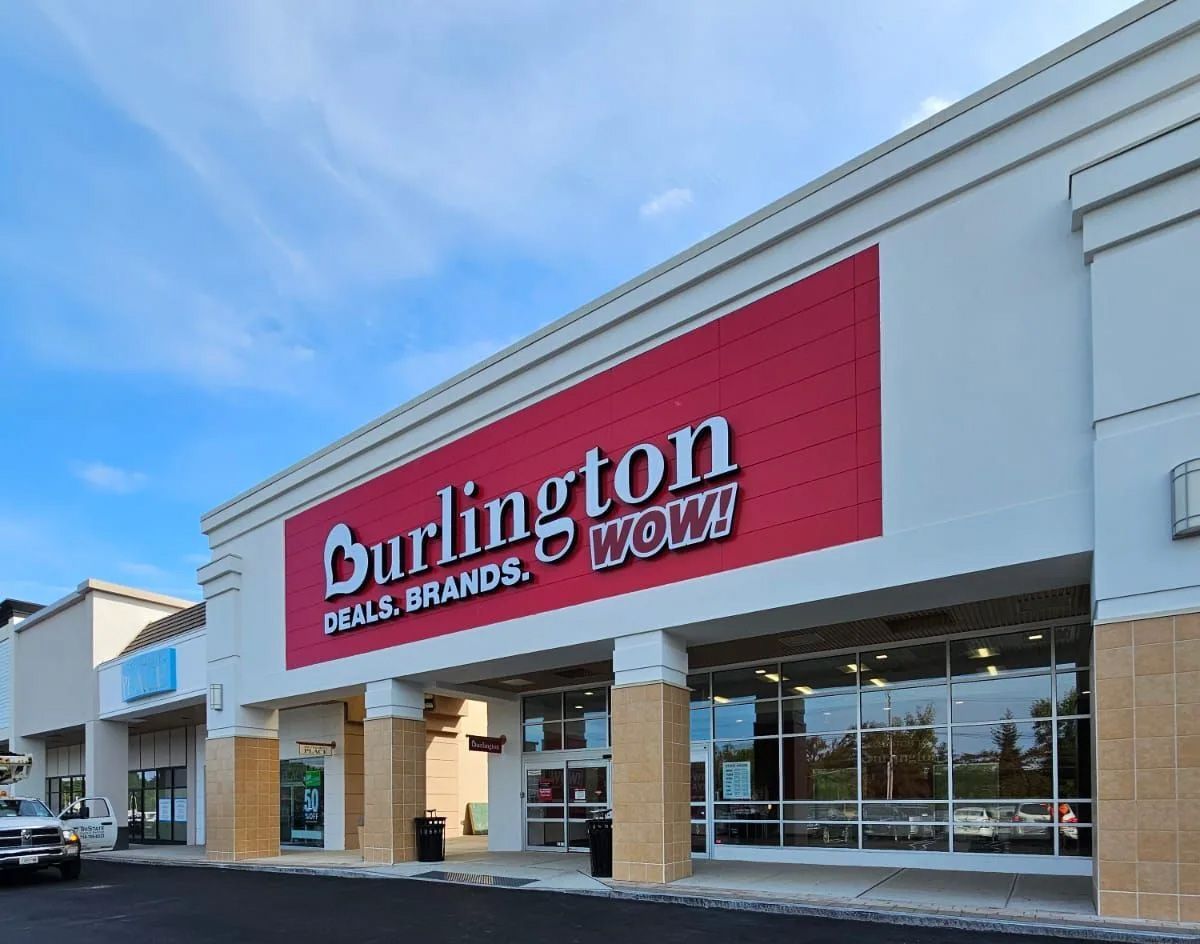 A white building with a red sign that says burlington