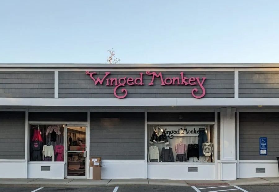 A storefront with a sign that says winged monkey