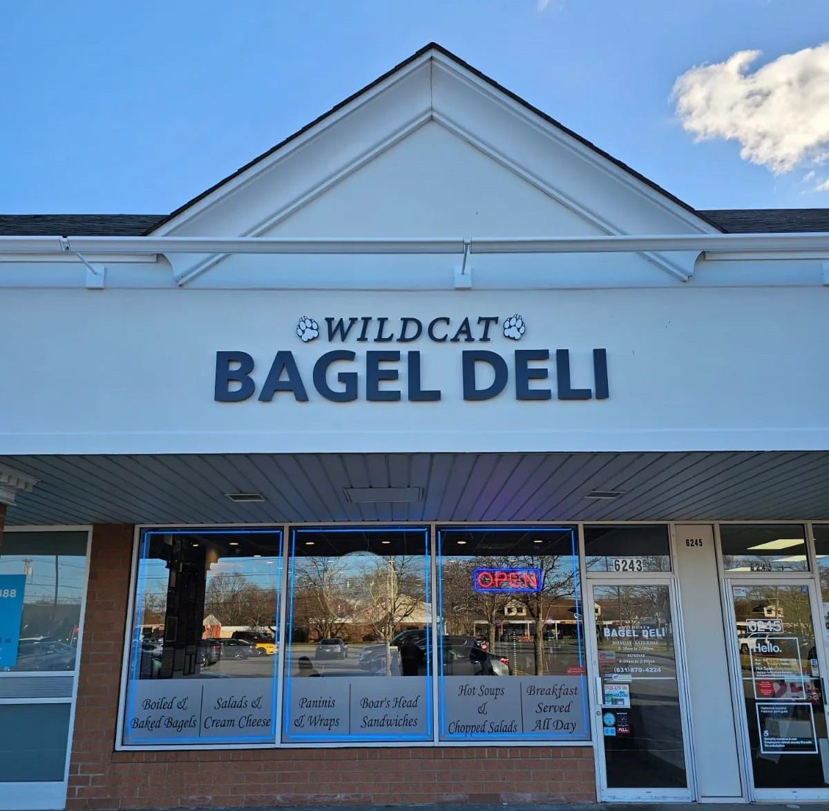 A storefront  with a sign that says wildcat bagel deli