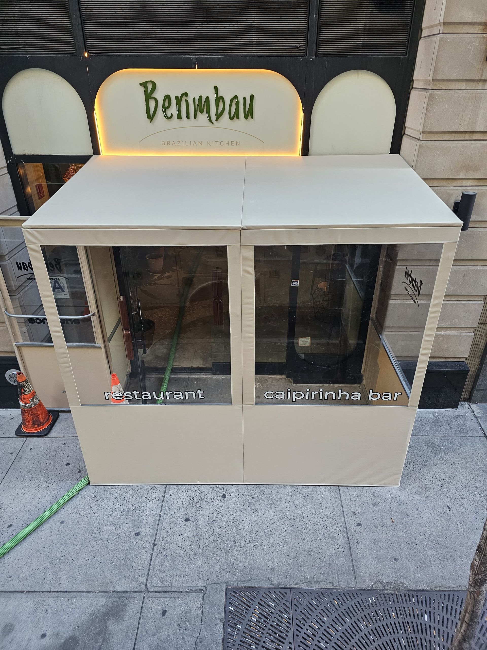 A white building with a sign that says berimbau on it.