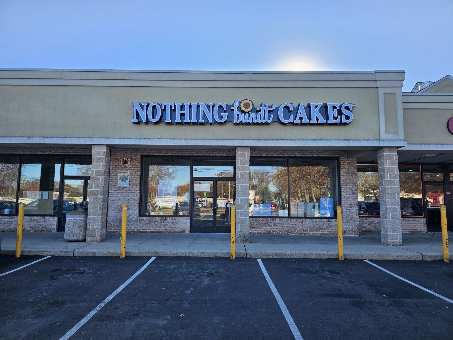 A brick building with a sign that says nothing but cakes