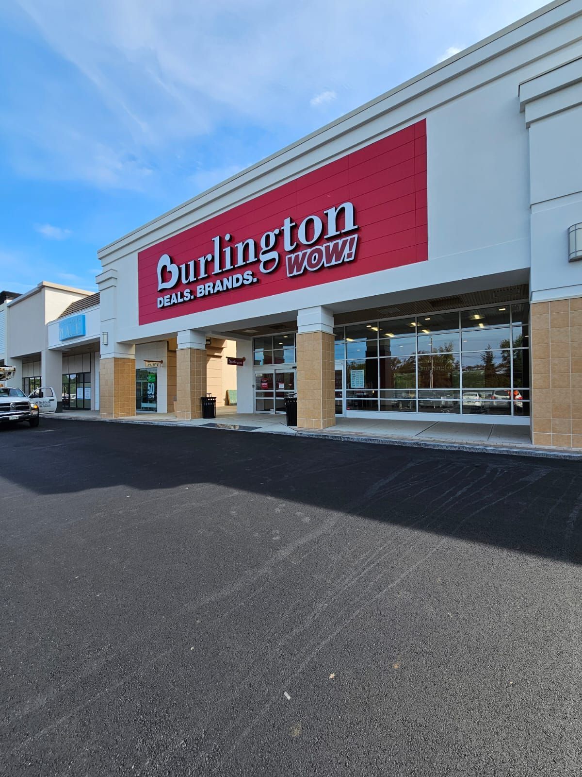 A white building with a red sign that says burlington home