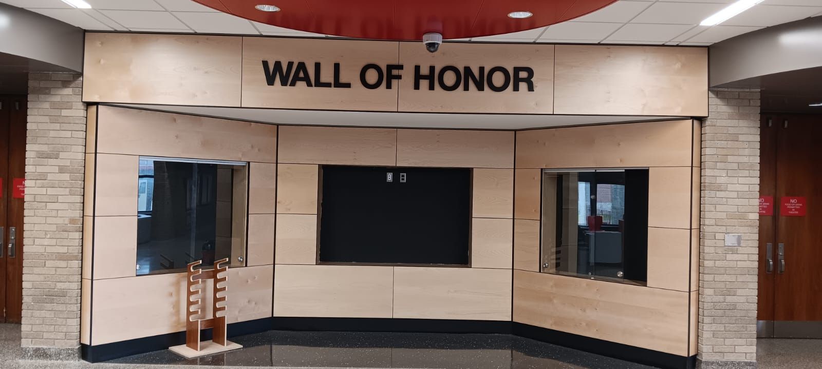 There is a wall of honor in the middle of a room.