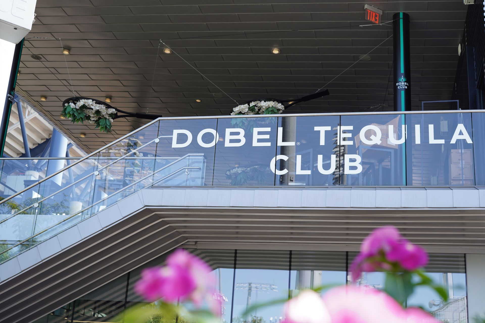 A building with a balcony and a sign that says dobel tequila club.