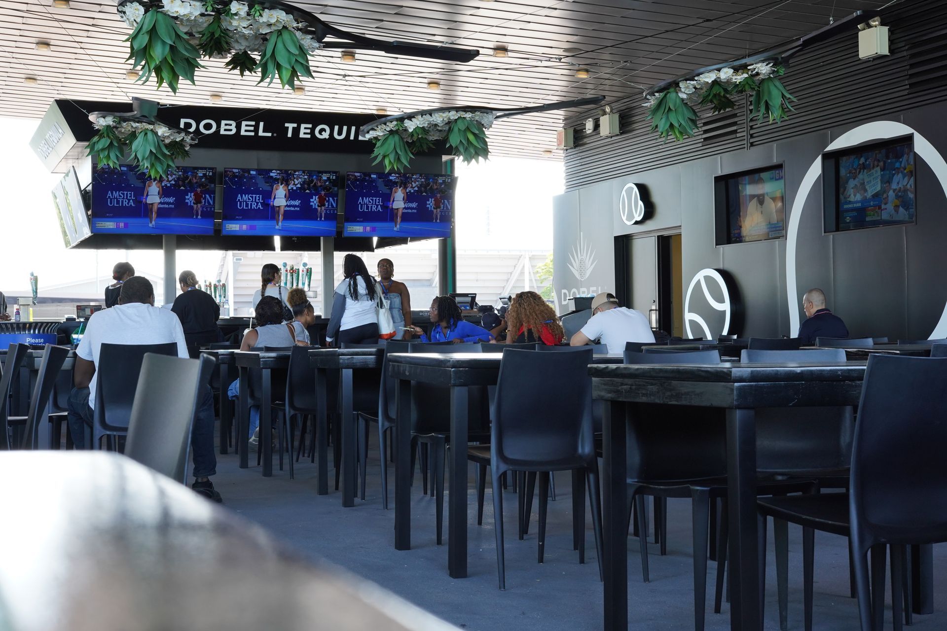 A group of people are sitting at tables in a restaurant.