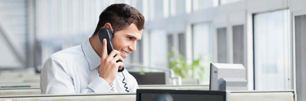 Businessman using telephone in office