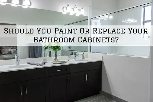 Bathroom with dark cabinets and a vanity mirror, overlaid text: “Should You Paint Or Replace Your Bathroom Cabinets?”