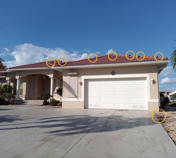 A house with a white garage door and a red roof