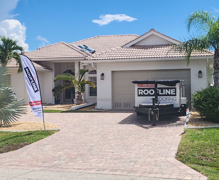 A house with a roof line trailer parked in front of it