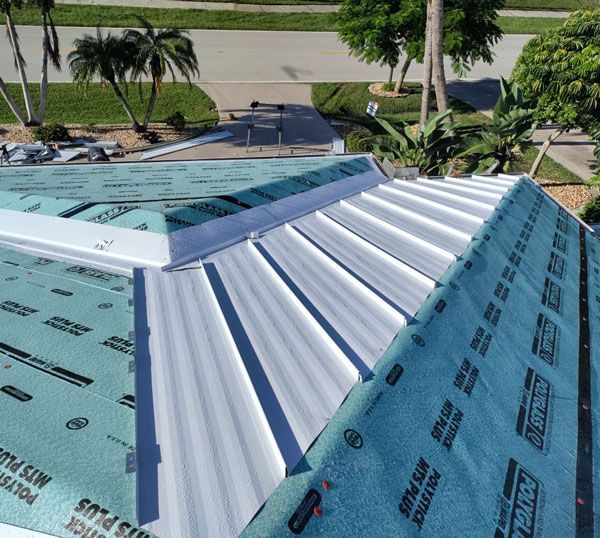 An aerial view of a roof with a roofing material that says polytech