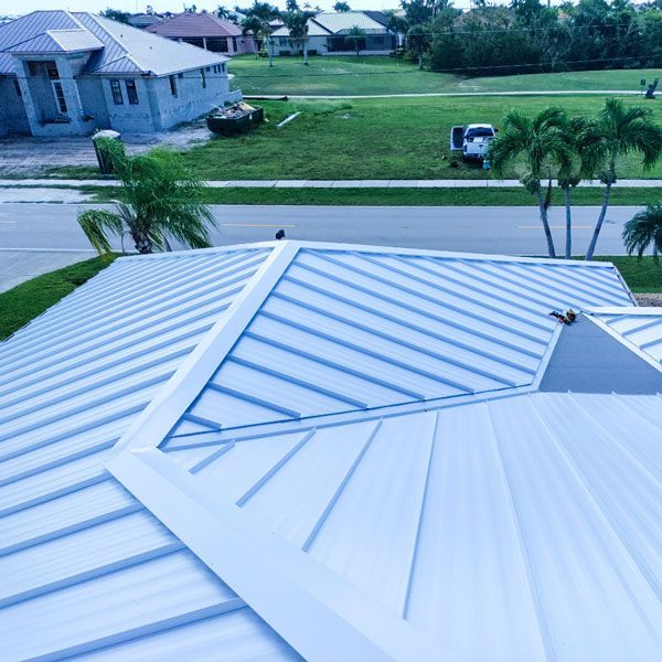 An aerial view of a house with a metal roof