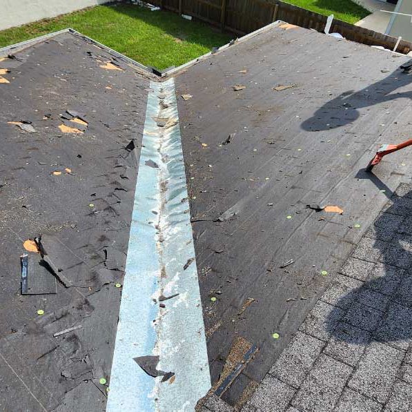 A roof with a metal gutter on it is being repaired.