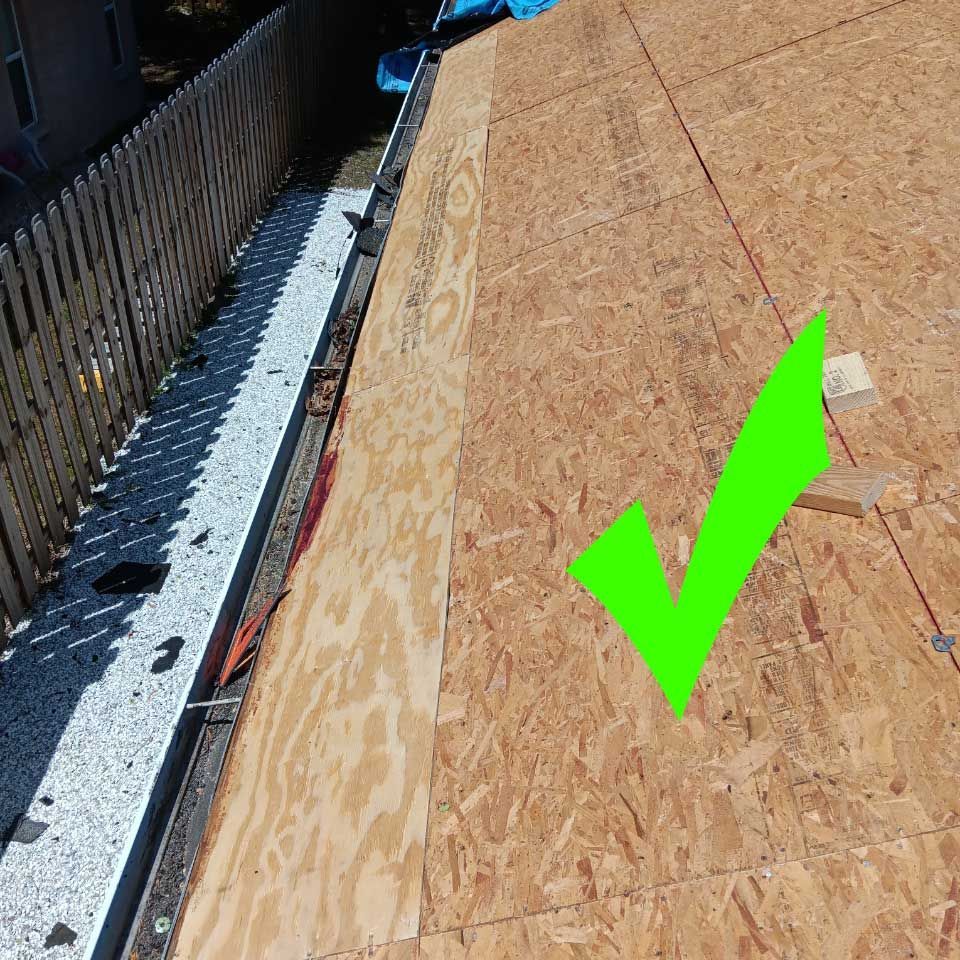 A roof with a green check mark on it.