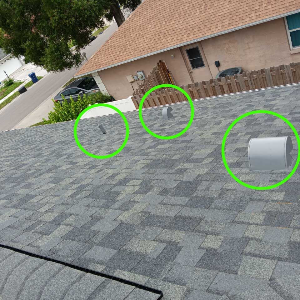 There are three green circles on the roof of a house.