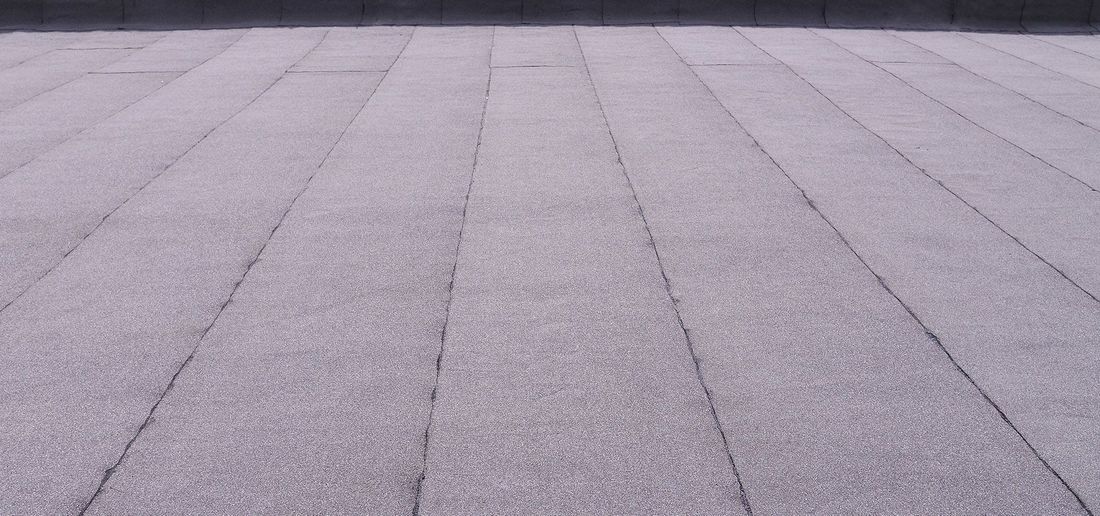 A close up of a purple tiled floor with a diagonal pattern.