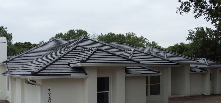 A white house with a black tile roof