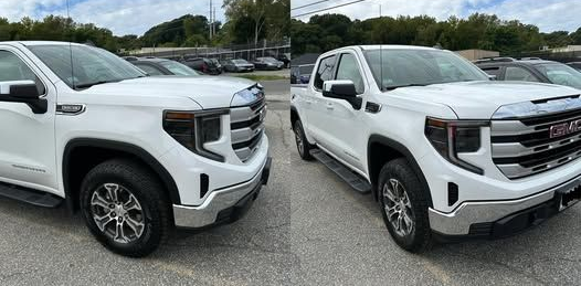 Silver Jeep Grand Cherokee with black wheels parked outdoors on a gray surface.