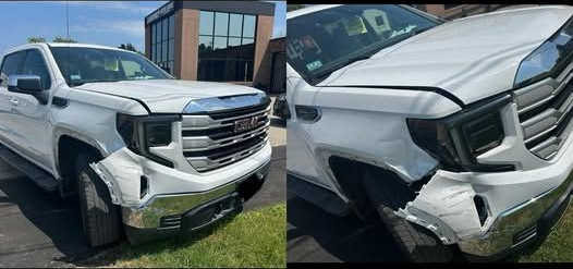 Silver Jeep Grand Cherokee with black wheels and front bumper damage.