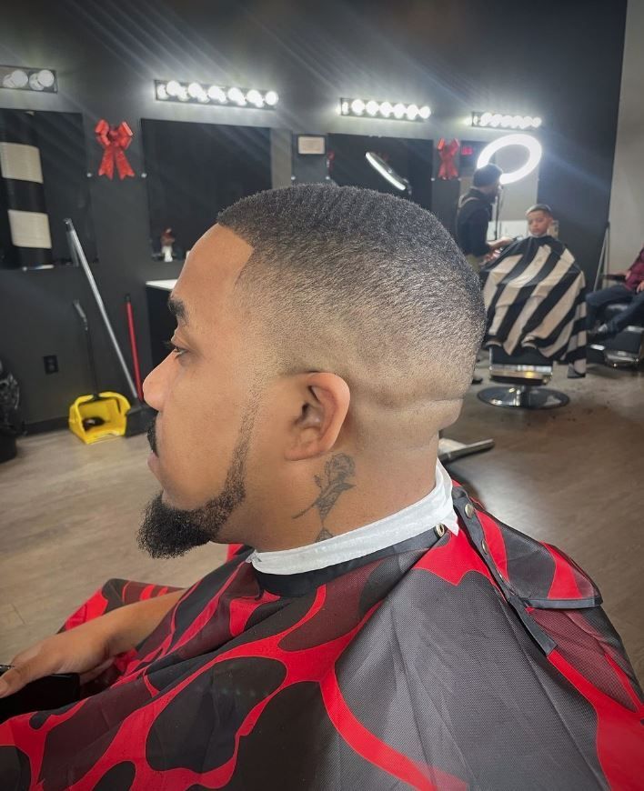 A man is getting his hair cut at a barber shop