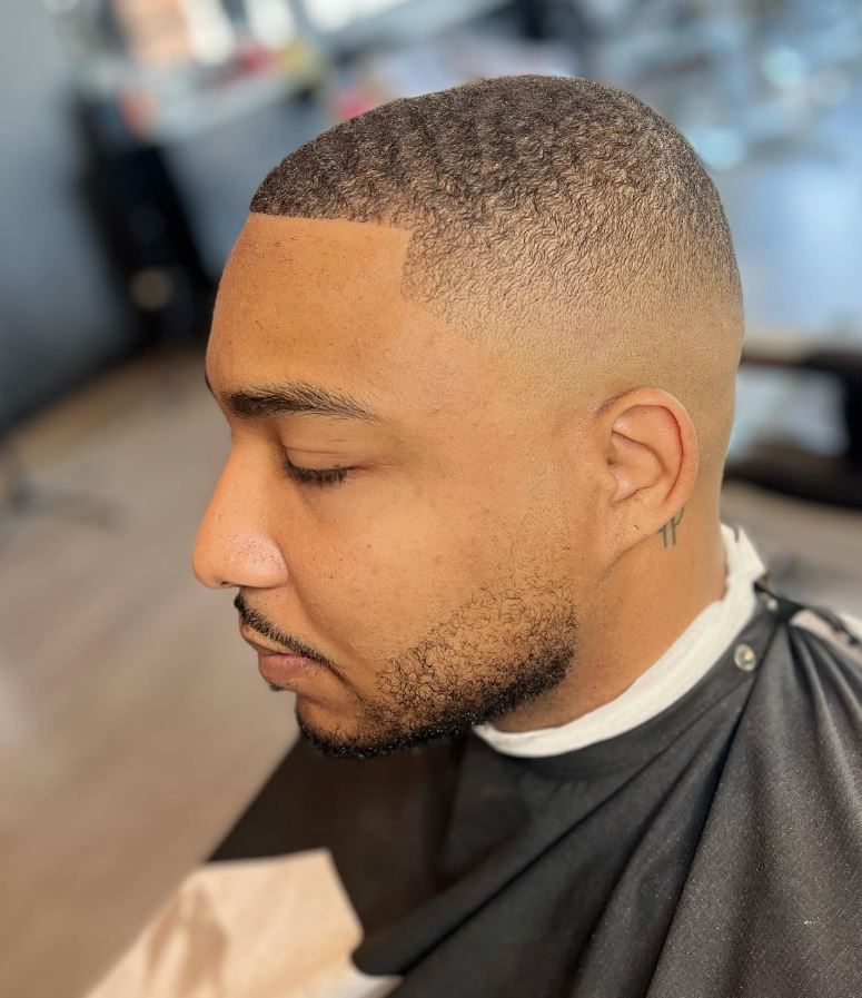 A man is getting his hair cut at a barber shop