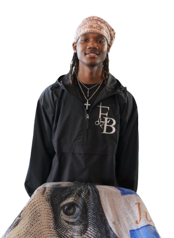 A man wearing a black jacket with the letter b on it