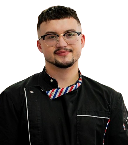 A man wearing glasses and a black jacket with a striped collar