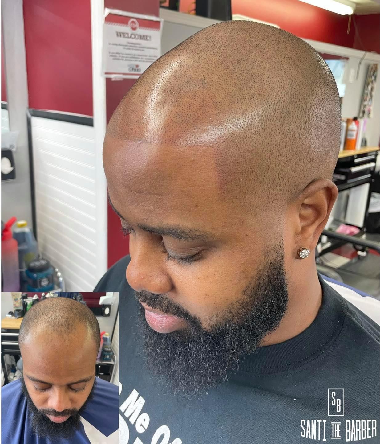 A man with a beard is getting his hair cut at a barber shop