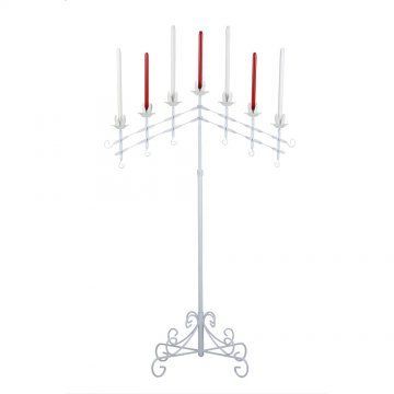 A white candelabra with red candles on it.