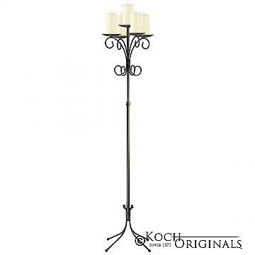 A wrought iron floor candle holder
