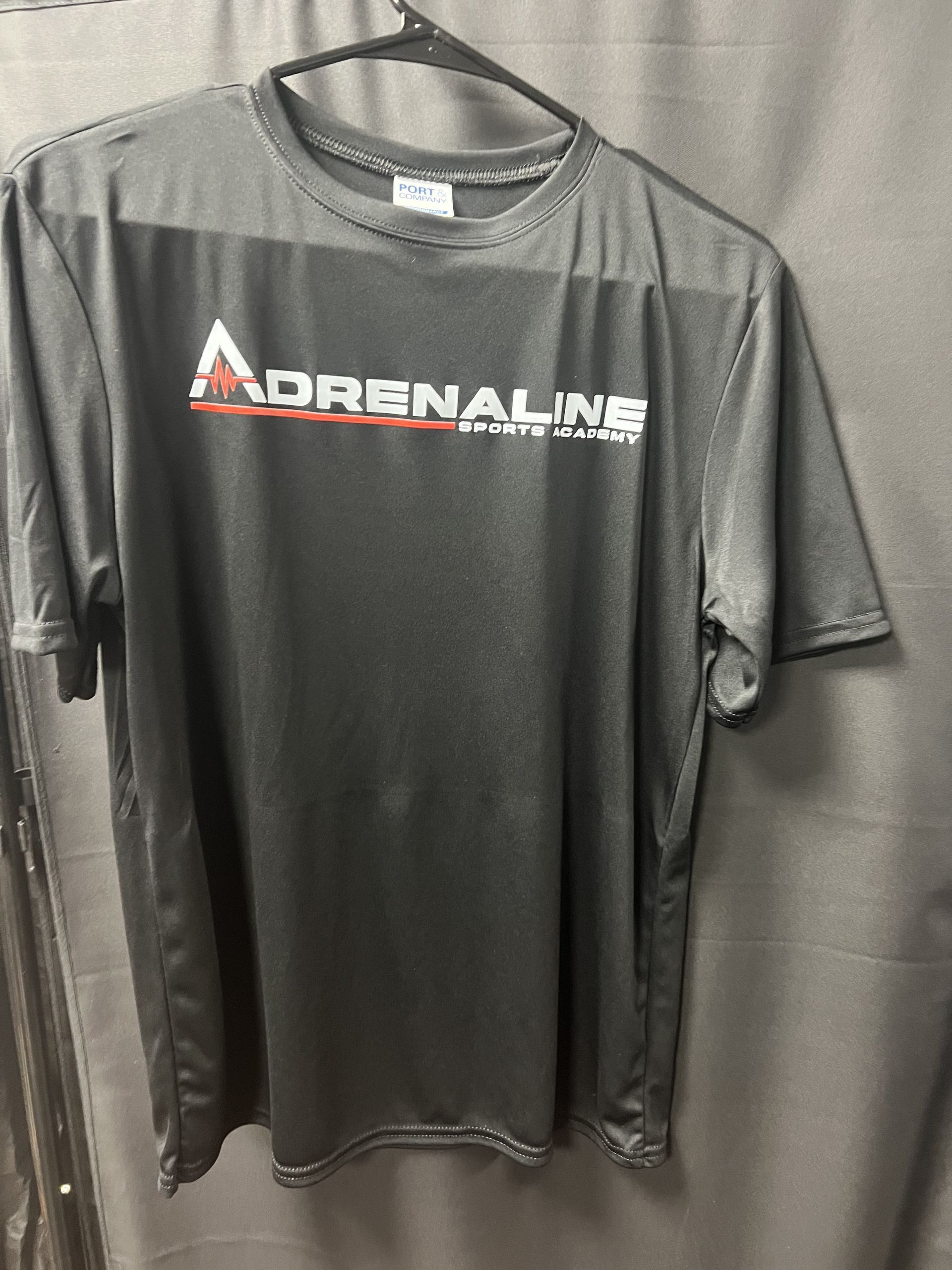 Black Adidas-style athletic shirt with “Adrenaline” logo hanging on a hanger
