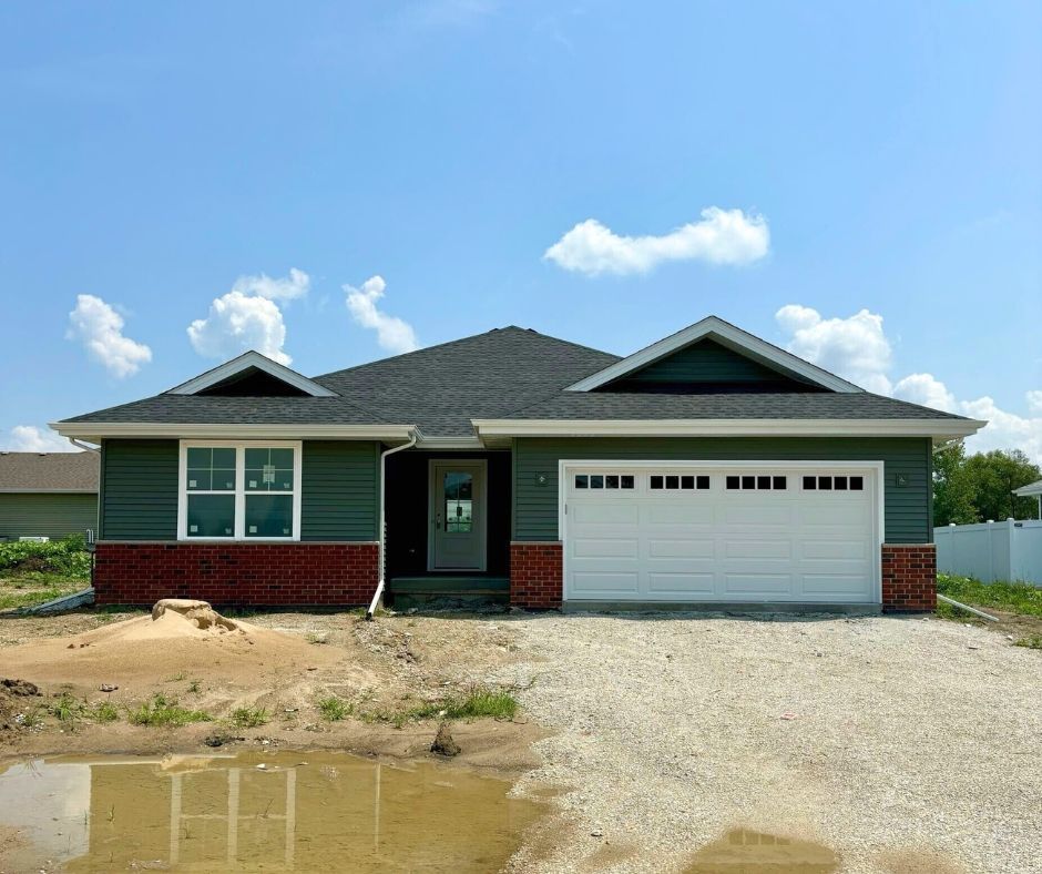 A house that is being built with a white garage door