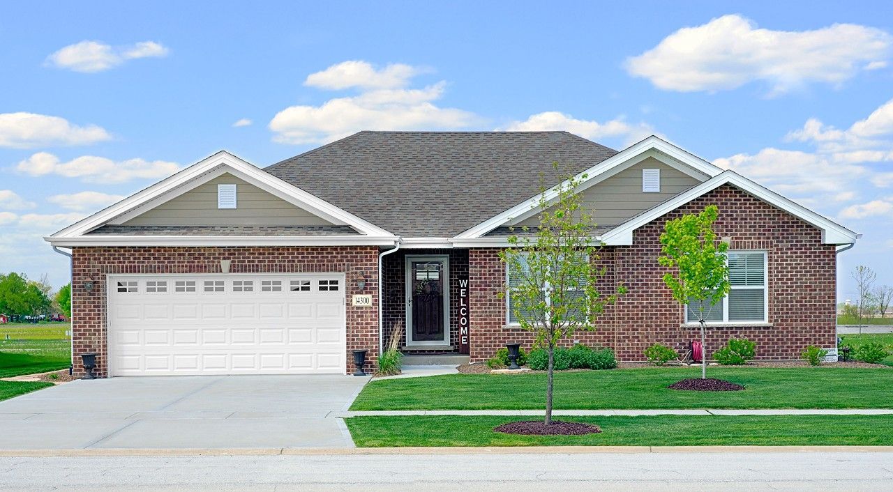 A large brick house with a white garage door.