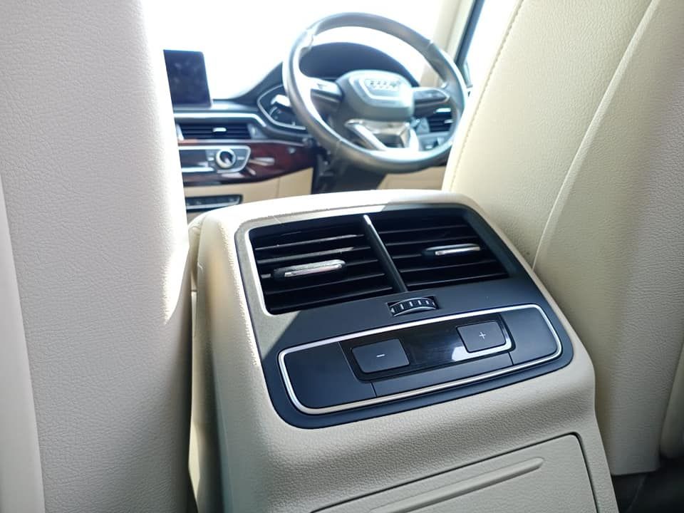 Rear car interior with air vents, center console, and steering wheel visible in the background.