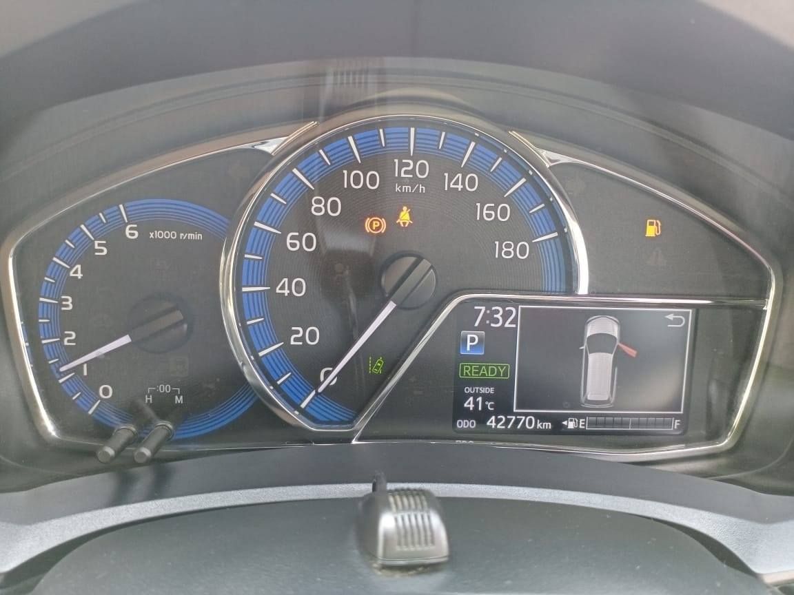 Car dashboard displaying speedometer, lights, and information screen.