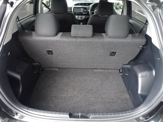 Empty black car trunk with rear seats folded down.