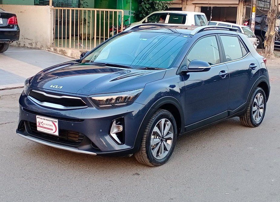 Blue Kia Stonic SUV parked on a city street.
