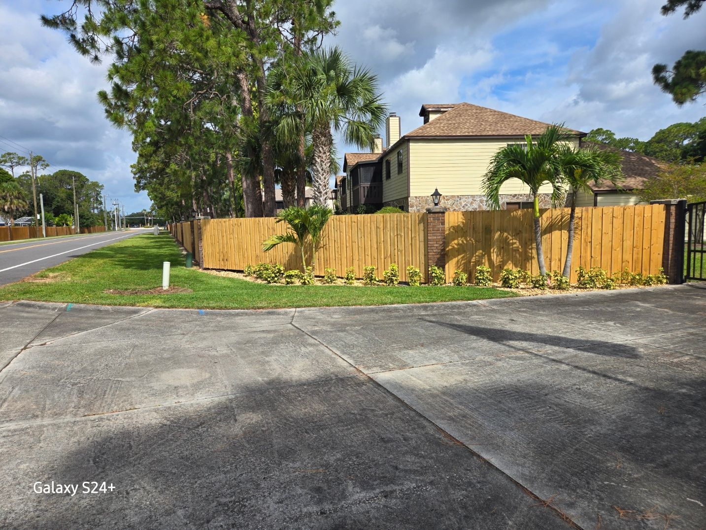 A house with a wooden fence in front of it