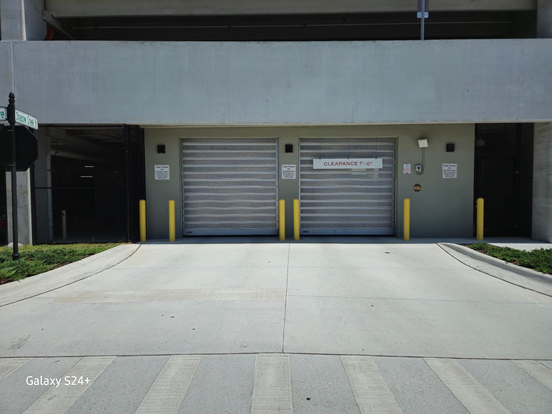 An empty parking garage with a sign.