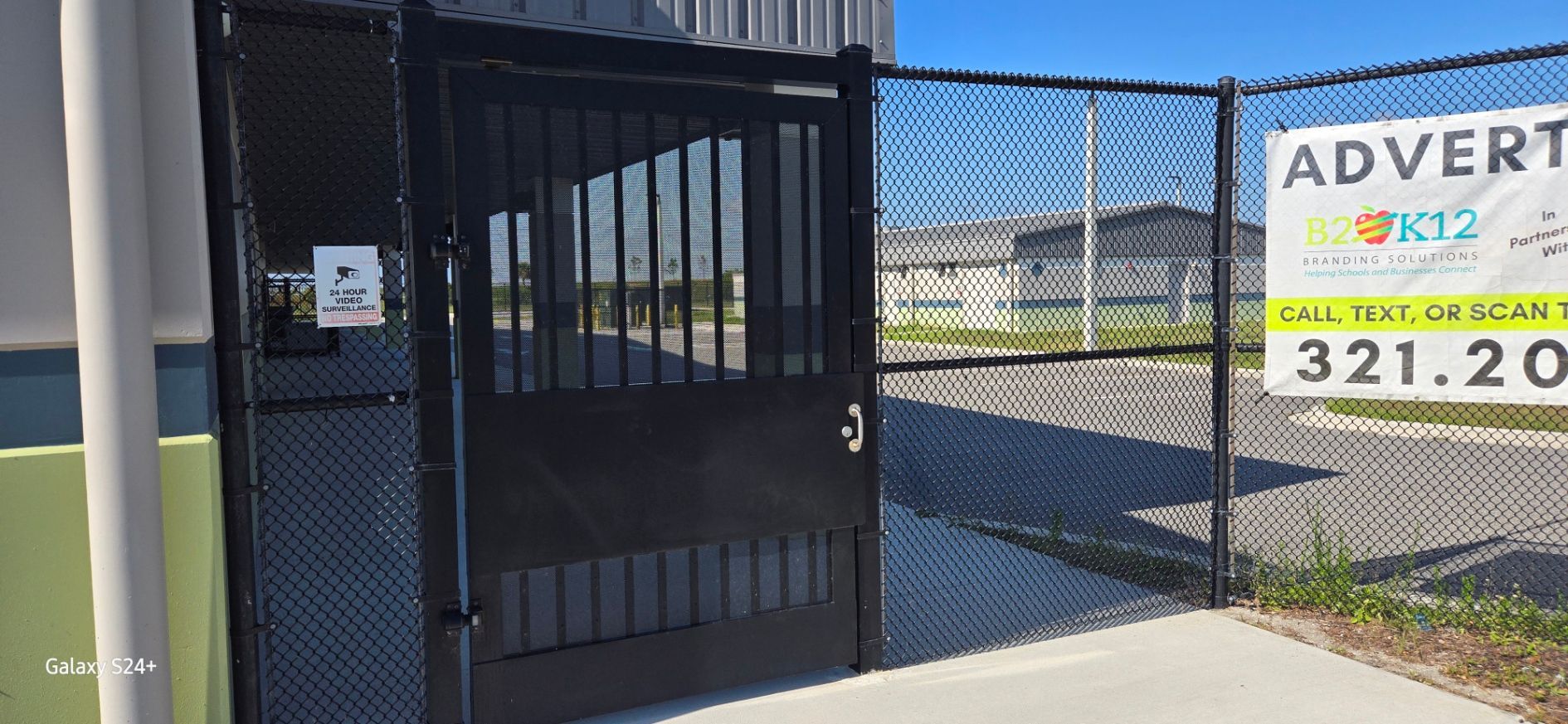 A fence with a sign that says advertisement on it