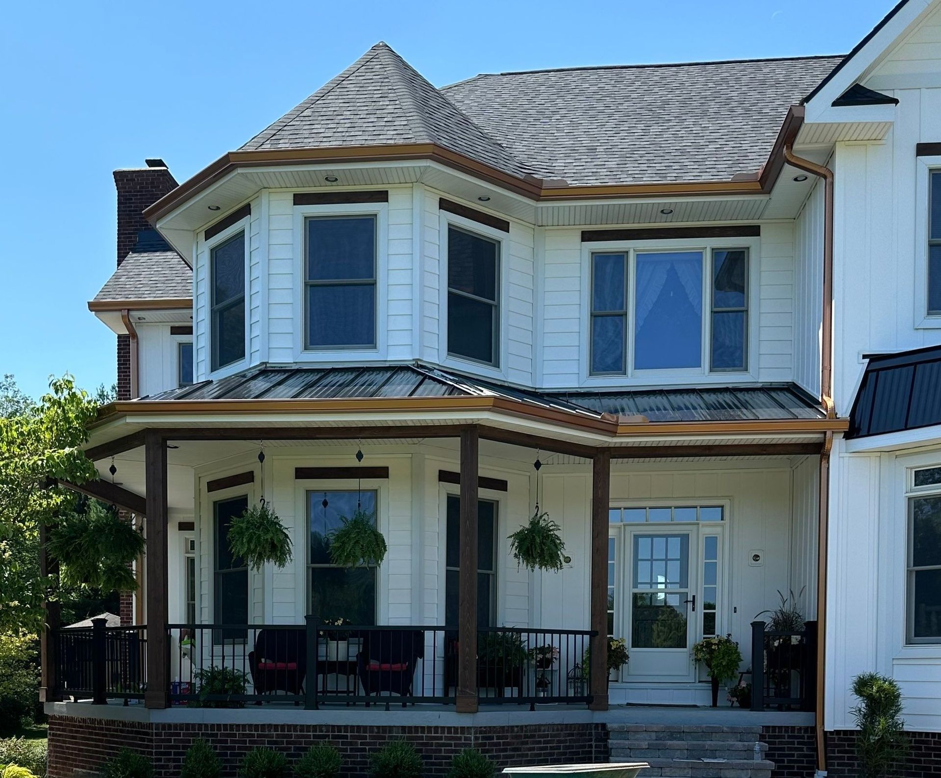Two-story suburban house with white siding, blue shutters, and a covered front porch
