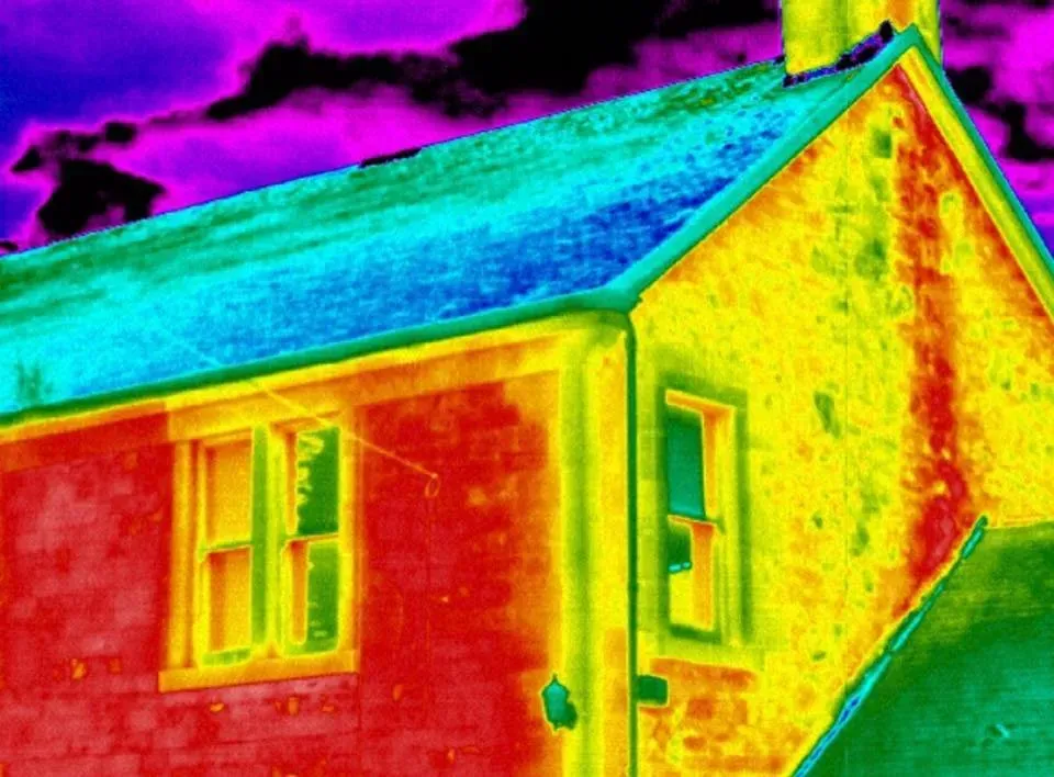 False-color view of a house with a blue roof and yellow walls under a purple sky