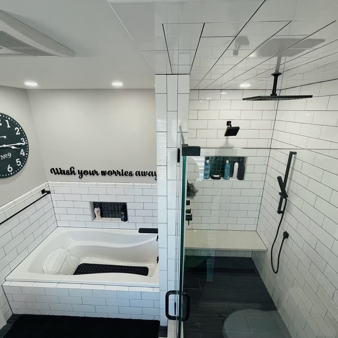 Modern bathroom with white subway tile, a bathtub, and a glass shower.