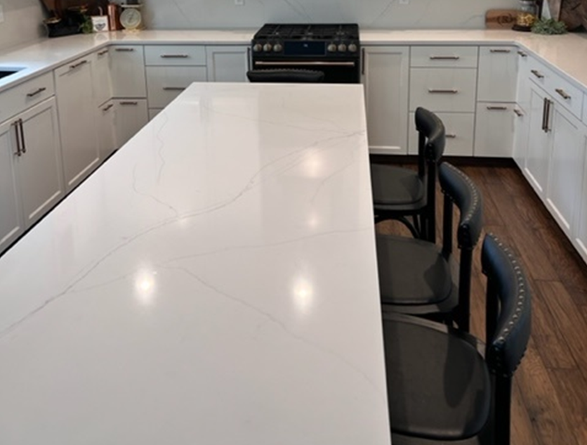 white countertop and black chairs, black stove