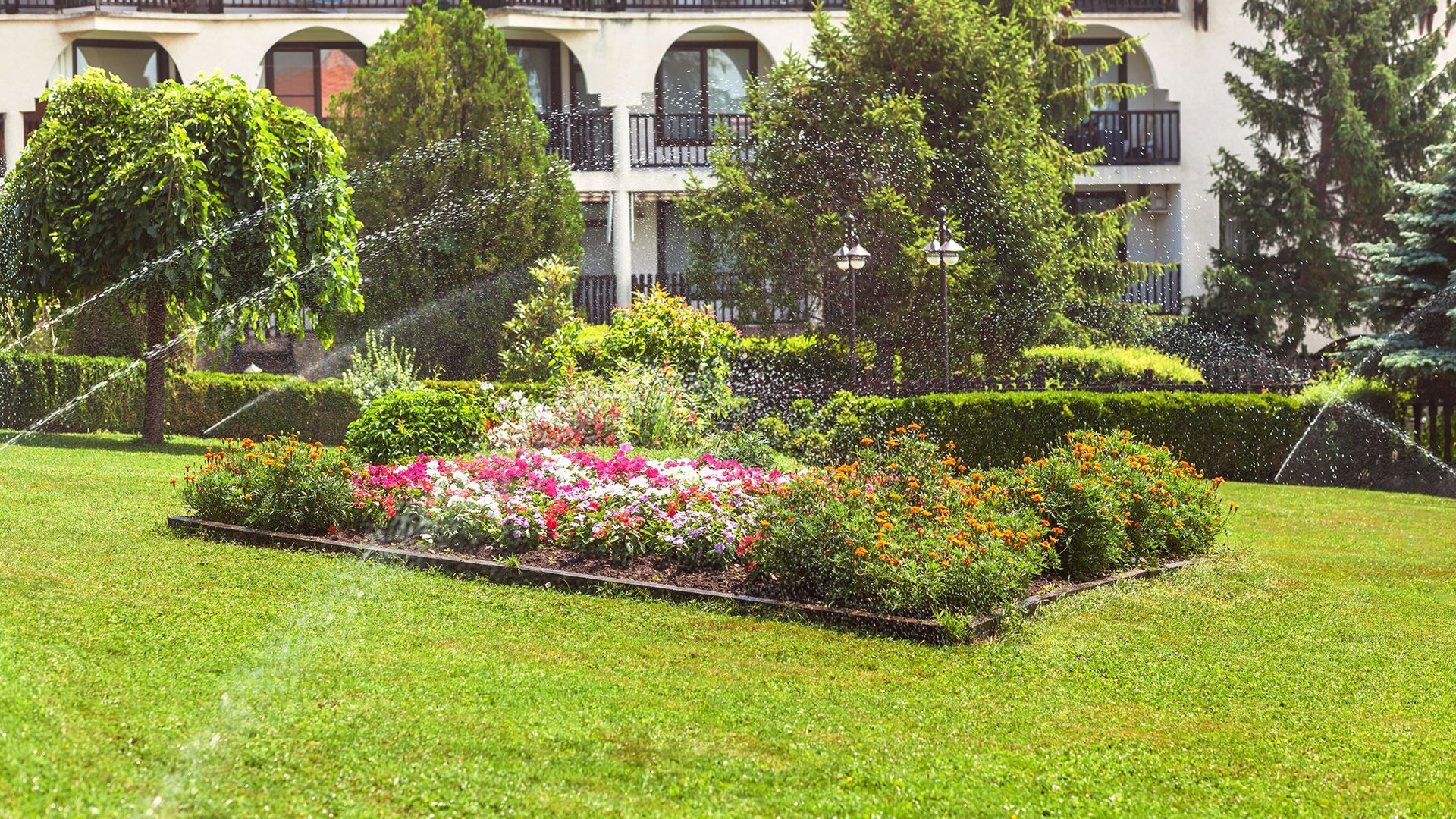 A blue pipe with a metal coupling and valve sits in a muddy trench during a water utility repair.